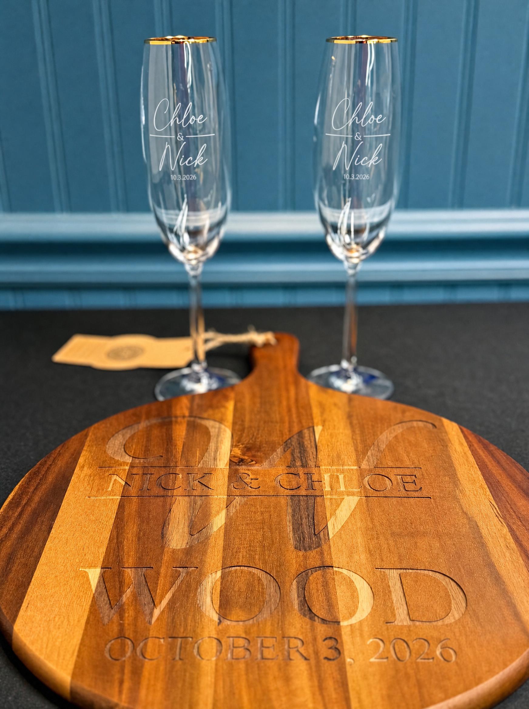 Laser-engraved round cutting board and gold-rim flute glasses for Nick and Chloe